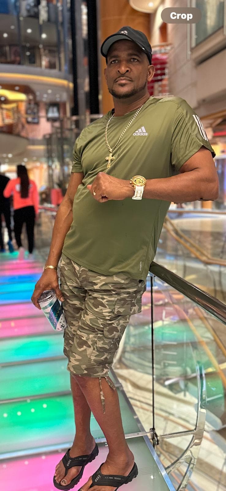 Rugged professional construction owner Mark Vitalis in a safety vest reviewing architectural blueprints on a sunny job site